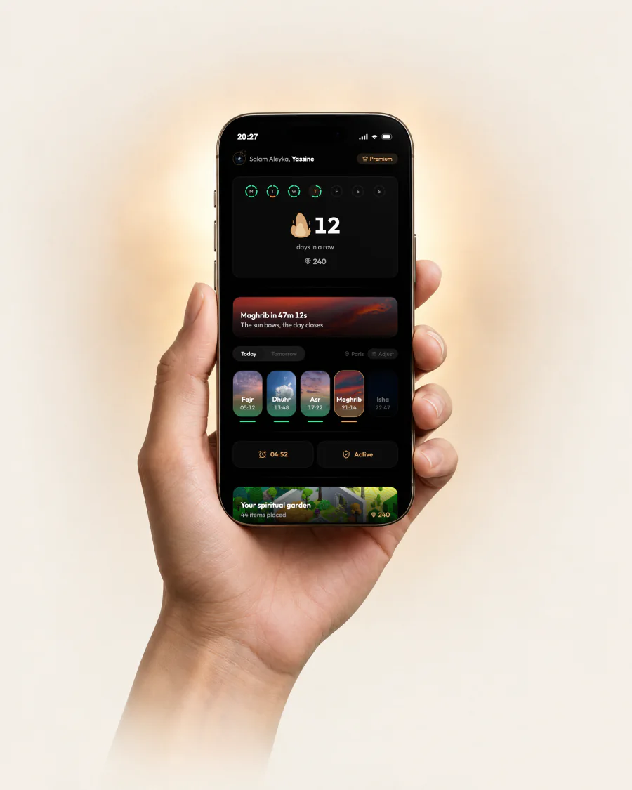 A hand holding an iPhone showing the ranks screen of Khushu.